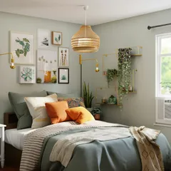 A calm bedroom with layered bedding, framed prints and plants
